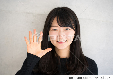 A woman waving a hand A woman waving a hand 44181407