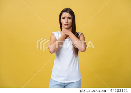 Sick woman suffering from sore throat isolated over yellow background. 44183121