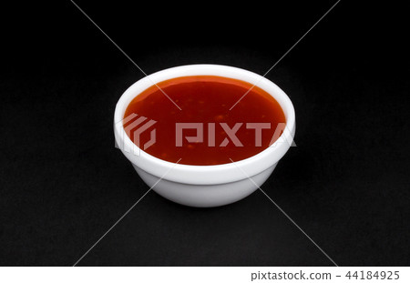 Hot chilli sauce in bowl isolated on black background Hot chilli sauce in bowl isolated on black background 44184925