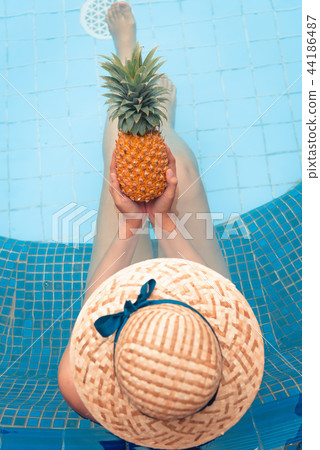Summer concept, Top view of woman holding pineappl 44186487
