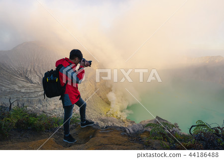 Photographer is shooting picture on top of mount 44186488