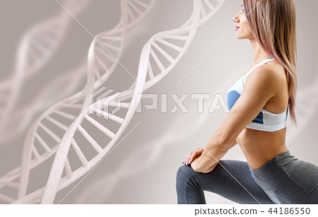 Athletic fitness woman standing among DNA chains. Athletic fitness woman standing among DNA chains. 44186550