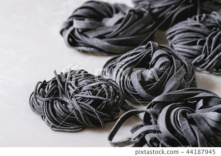 Fresh uncooked black pasta 44187945