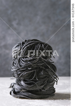 Fresh uncooked black pasta Fresh uncooked black pasta 44187946