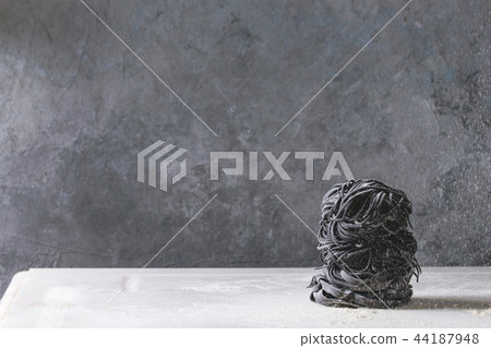 Fresh uncooked black pasta Fresh uncooked black pasta 44187948