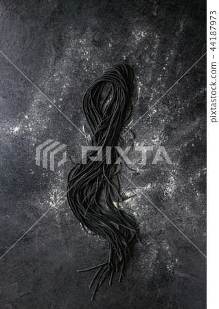 Fresh uncooked black pasta Fresh uncooked black pasta 44187973