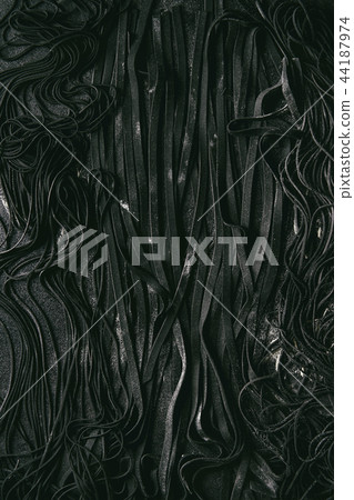 Fresh uncooked black pasta Fresh uncooked black pasta 44187974