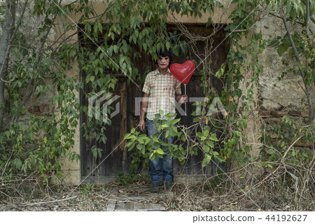 scary disfigured man with a balloon. 44192627