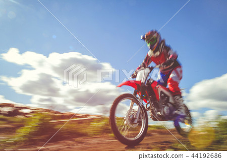 woman on enduro motocross in motion, 44192686
