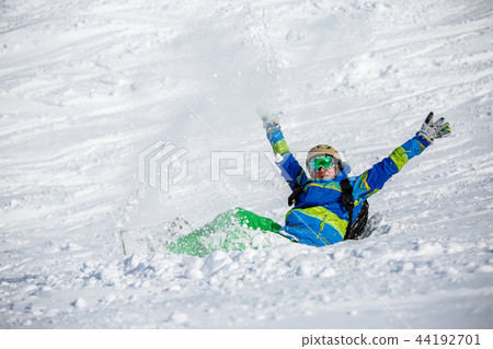 Image of sports man with snowboard lying on snowy slope Image of sports man with snowboard lying on snowy slope 44192701