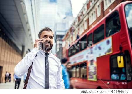 Hipster businessman on the street in London, making a phone call. Hipster businessman on the street in London, making a phone call. 44194662