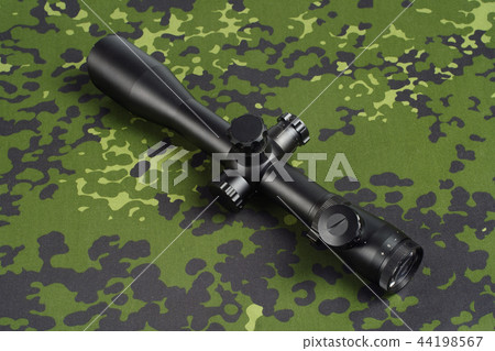 sniper scope on camouflage background sniper scope on camouflage background 44198567