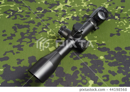 sniper scope on camouflage background sniper scope on camouflage background 44198568