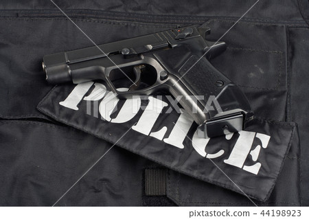 police handgun on black uniform background 44198923