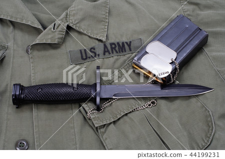 M16 rifle bayonet on uniform background M16 rifle bayonet on uniform background 44199231