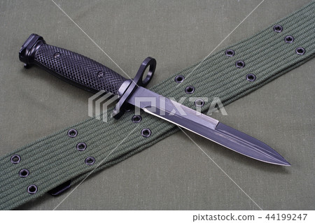 M16 rifle bayonet on uniform background 44199247