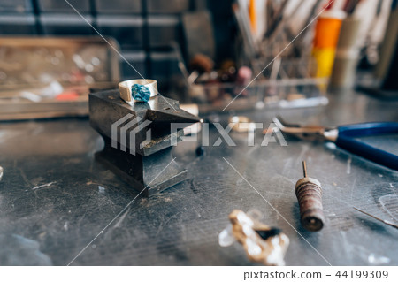 Different jewelery on the table from the jeweler from a close angle Different jewelery on the table from the jeweler from a close angle 44199309