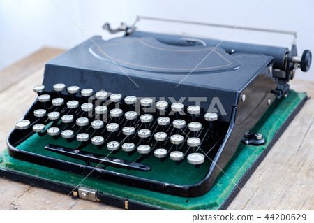 Antique typewriter in vintage and grunge looks on a wooden table. 44200629