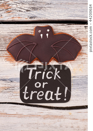 Halloween bat cookie on wooden background. 44200684