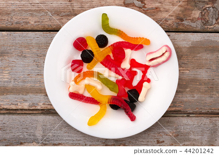 Plate with colorful jelly candies. 44201242