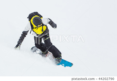 Man snowboarder riding on slope. 44202790