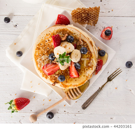 delicious pancakes on wooden table with fruits 44203161