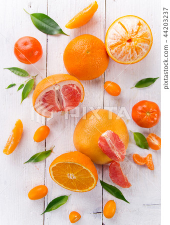 Citrus fruits on white wooden table. Citrus fruits on white wooden table. 44203237