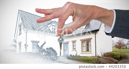 Composite image of cropped hand of businessman holding key 44203358