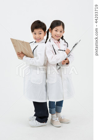 Children education. Young boy and girl wearing doctor uniform with stethoscope in white background 185 44203719