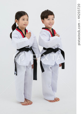 Children education. Taekwondo, little boy and girl practice martial arts in white background 255 Children education. Taekwondo, little boy and girl practice martial arts in white background 255 44203720