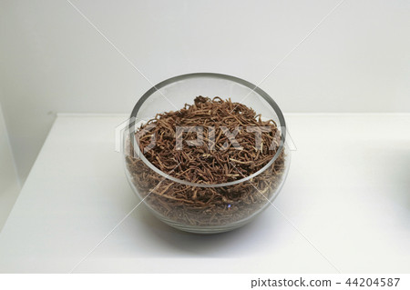 Chinese traditional medicine, dry leaves in glass bowl white isolated background. 113 Chinese traditional medicine, dry leaves in glass bowl white isolated background. 113 44204587