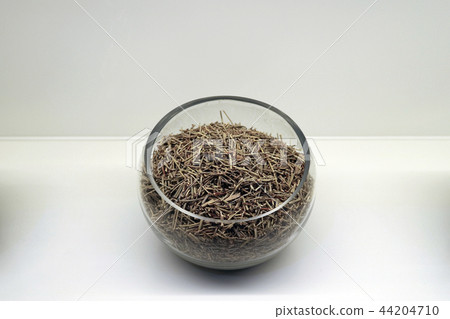 Chinese traditional medicine, dry leaves in glass bowl white isolated background. 087 Chinese traditional medicine, dry leaves in glass bowl white isolated background. 087 44204710