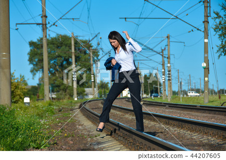 A woman in an office suit breaks the traffic rules A woman in an office suit breaks the traffic rules 44207605