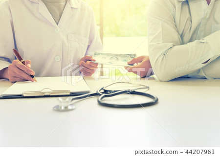 Business man or patient give bribe to the docto 44207961