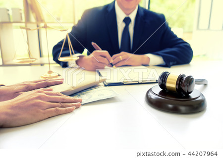 Judge lawyer gavel with bribe money in law firm 44207964