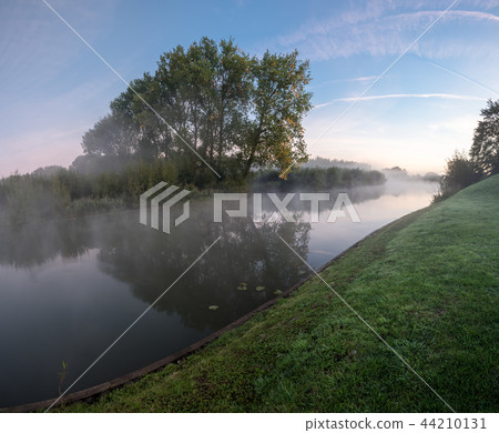 an misty morning at the water 44210131