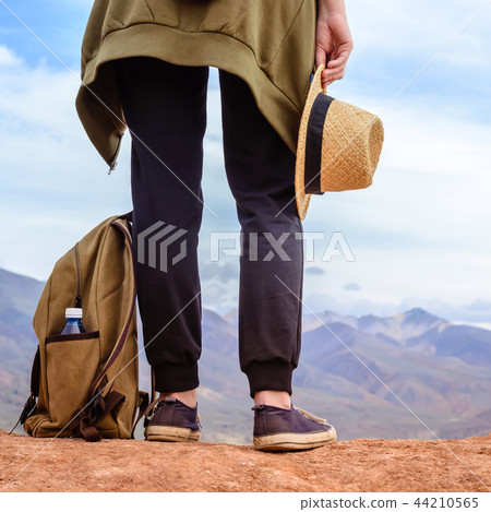Girl tourist stands on hill. Legs of traveler 44210565