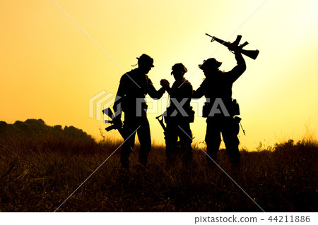 Soldier holding weapons overhead after get victory Soldier holding weapons overhead after get victory 44211886