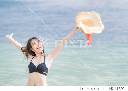 Pretty woman having fun and relax on beach. 44211891