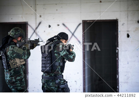 Asian army soldier with rifle moving patrol. Asian army soldier with rifle moving patrol. 44211892