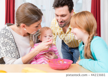 Close-up of happy family taking care of baby Close-up of happy family taking care of baby 44213881