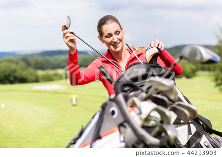 Golfer choosing club from bag 44213903