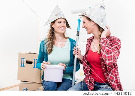Two female friends renovating their new house Two female friends renovating their new house 44214012