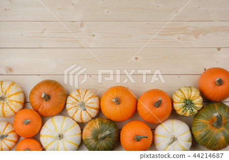 Pumpkins on wooden background 44214687