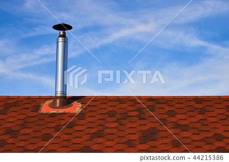 Metal chimney on the red roof Metal chimney on the red roof 44215386