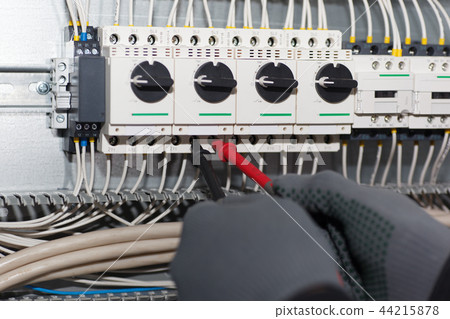 Engineer electrician is testing an electric machin 44215878