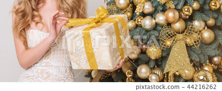 Happy woman opening gift box. Luxury blonde with Christmas gift. Merry Christmas and Happy New Year Happy woman opening gift box. Luxury blonde with Christmas gift. Merry Christmas and Happy New Year 44216262