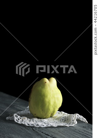 quince fruit on a wooden table 44216705