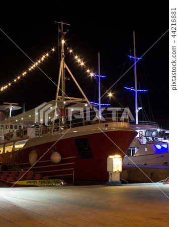 Night view of illuminated ships in port 44216881