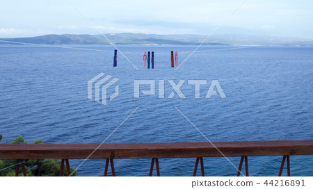 Clothespins hanging on clothesline and sea (3) 44216891